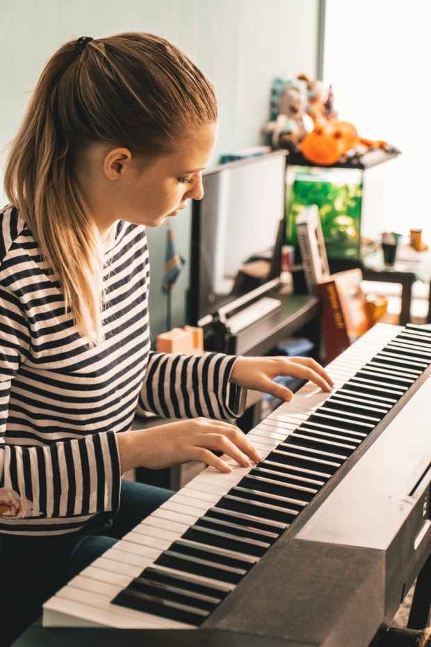 photo of woman playing piano